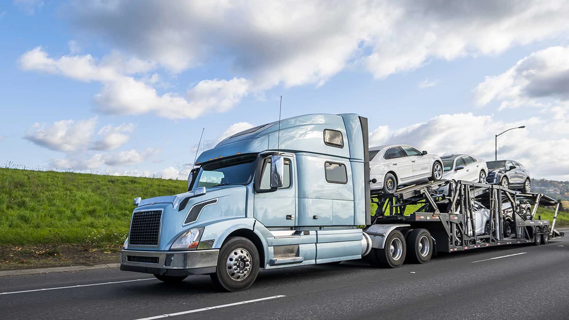 Open car carrier hauling vehicles on a long-haul interstate route